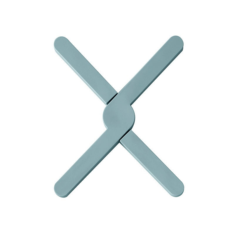 X-shaped heat-resistant silicone dining table mat with non-slip design. Protects surfaces from heat, spills, and scratches—stylish and practical for everyday use.