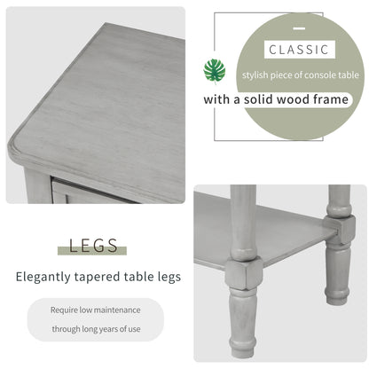 Slim grey-washed console desk with three drawers and bottom shelves. Space-saving sofa table perfect for living rooms, entryways, and hallways.