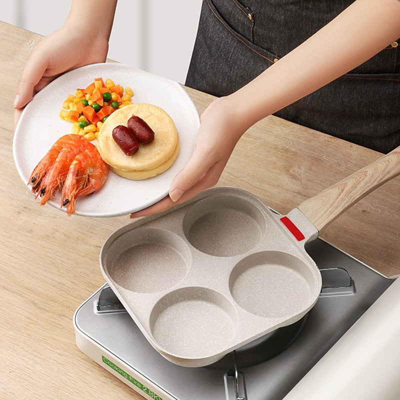 Non-stick four-hole breakfast pan for frying eggs, pancakes, and burger toppings evenly. Perfect for quick, mess-free home cooking.