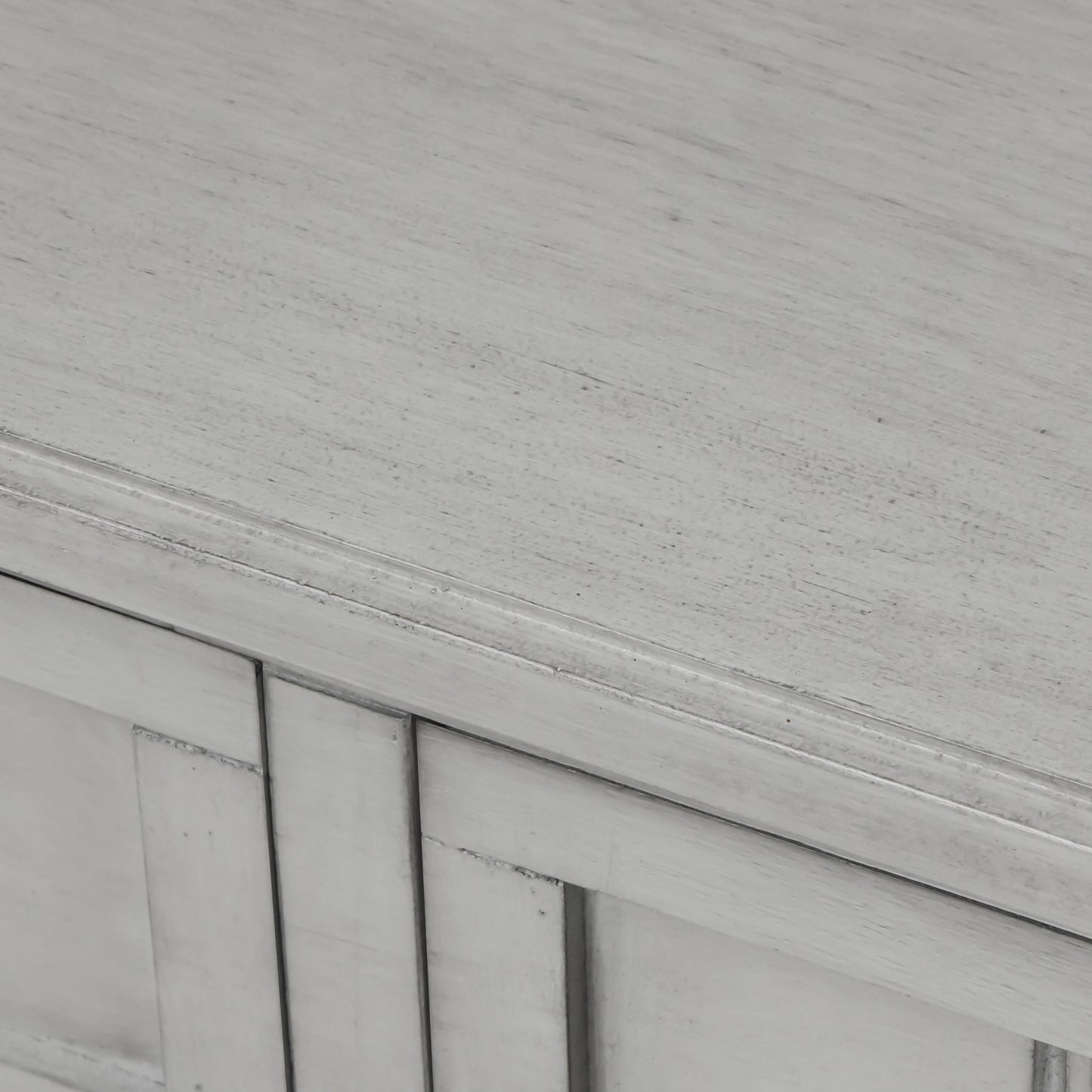 Slim grey-washed console desk with three drawers and bottom shelves. Space-saving sofa table perfect for living rooms, entryways, and hallways.