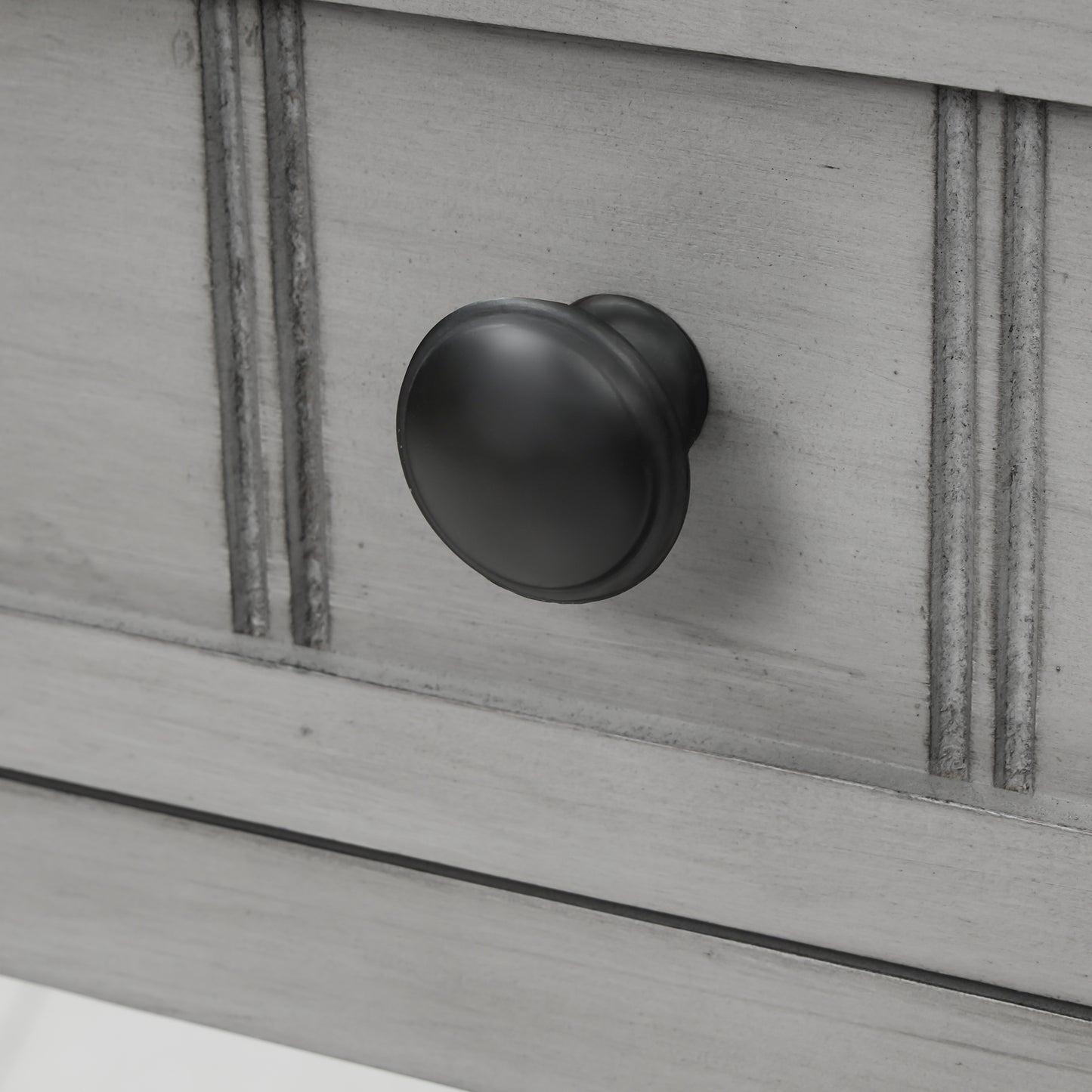 Slim grey-washed console desk with three drawers and bottom shelves. Space-saving sofa table perfect for living rooms, entryways, and hallways.