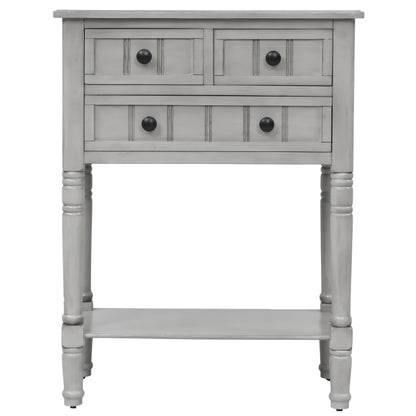 Slim grey-washed console desk with three drawers and bottom shelves. Space-saving sofa table perfect for living rooms, entryways, and hallways.